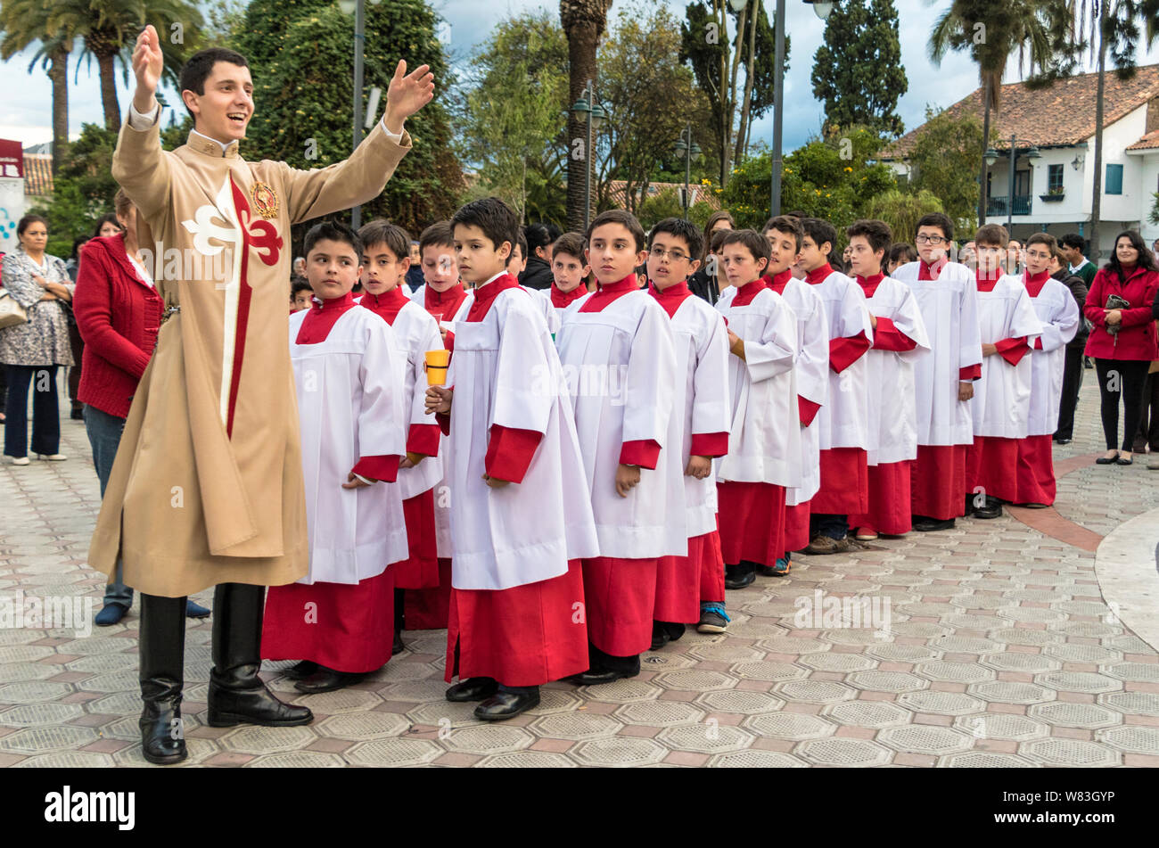 Cuenca, Équateur - 4 juin 2015 - prêtre curé catholique stagiaire parle aux jeunes garçons avant la procession Corpus Cristi Banque D'Images