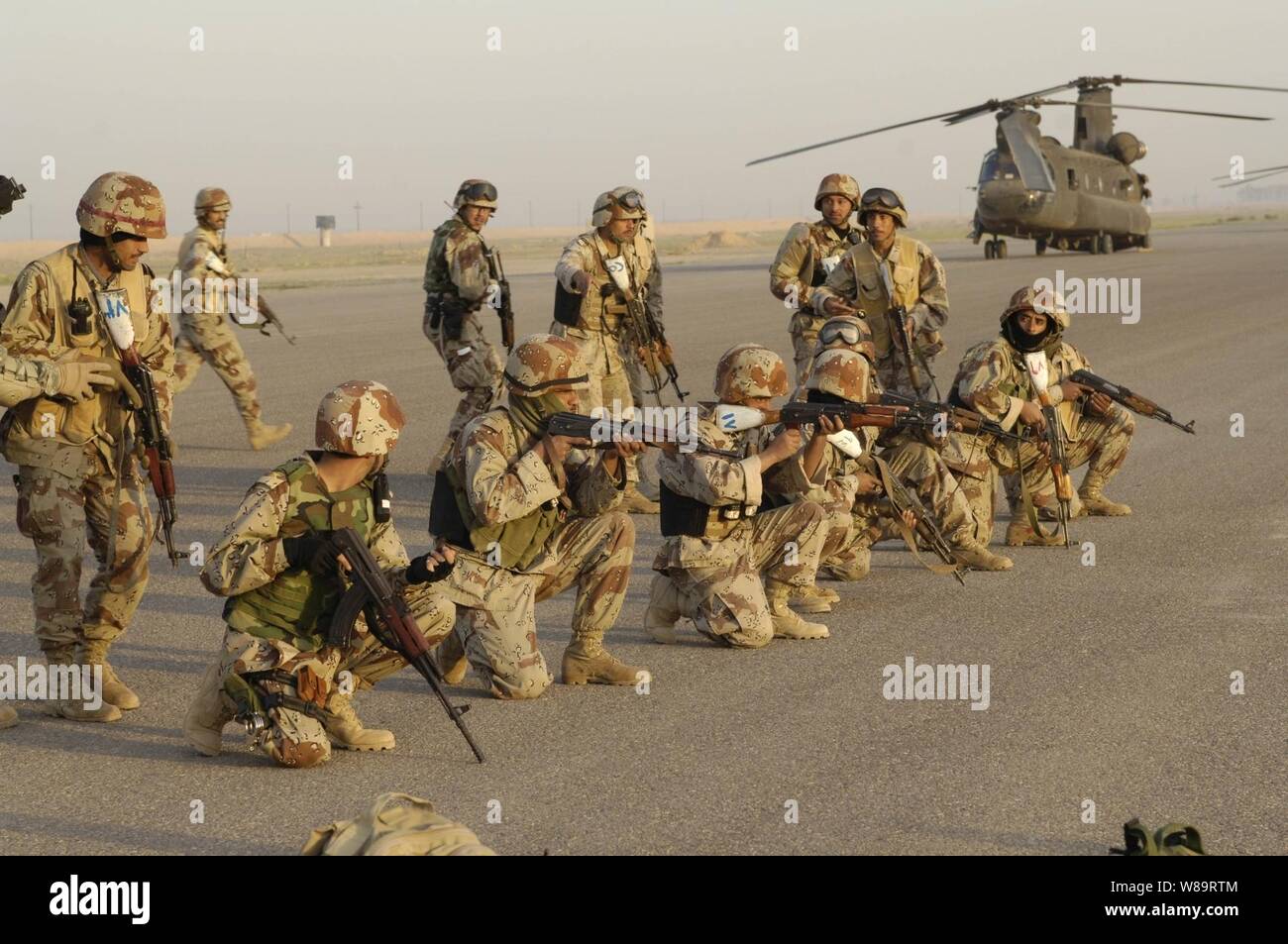 Les soldats de l'armée iraquienne de répéter le mouvement initial d'un hélicoptère CH-47 Chinook de l'armée avant le décollage pour une opération d'assaut aérien à partir de la base d'opérations avancée, Remagen, l'Iraq, le 31 mars 2006. Les soldats sont de l'armyís1er Bataillon, 1e Brigade, 4e Division. Banque D'Images