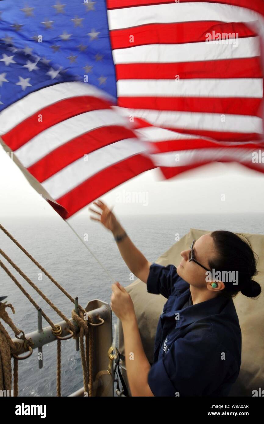 Matelot Ingrid Devinkayne définit les couleurs du 4 juillet sur le pont du porte-avions USS Ronald Reagan (CVN 76) dans la mer d'Oman le 4 juillet 2011. Le Ronald Reagan et le transporteur Air Wing 14 sont déployés dans le 5e Flotte des États-Unis zone de responsabilité la conduite des missions de l'appui aérien rapproché dans le cadre de l'opération Enduring Freedom. Banque D'Images