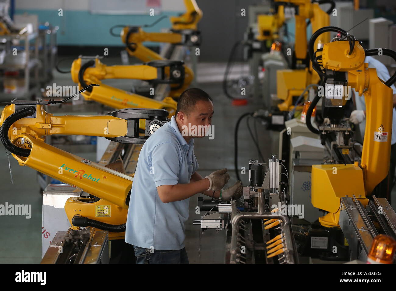 --FILE--un travailleur d'usine chinois bras robot essais à l'usine de Shanghai EverRobot robotique Co., Ltd. à Jiaxing City, Zhejiang Province de la Chine de l'Est Banque D'Images --FILE--un travailleur d'usine chinois bras robot essais à l'usine de Shanghai EverRobot robotique Co., Ltd. à Jiaxing City, Zhejiang Province de la Chine de l'Est Banque D'Images