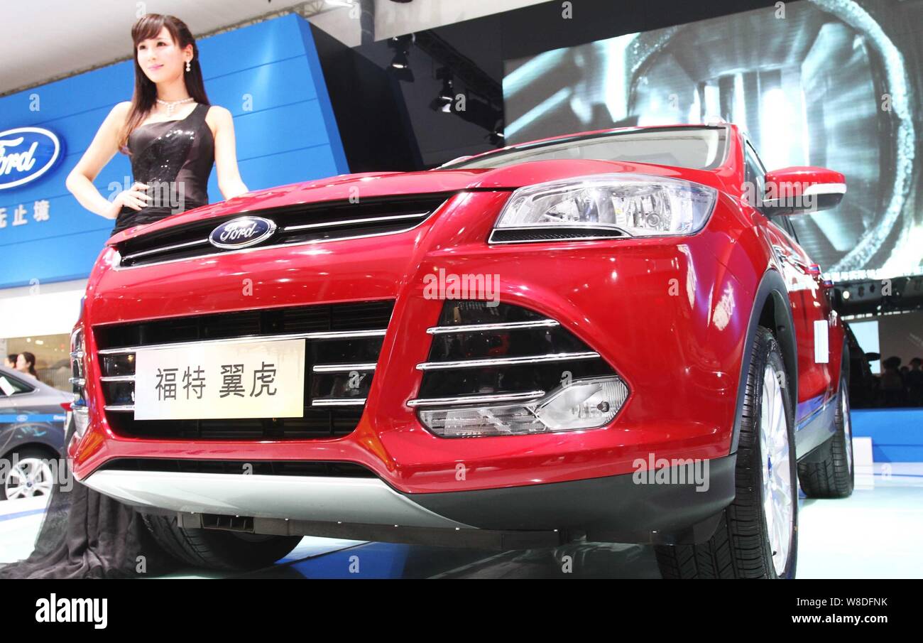 --FILE--un modèle pose avec une Ford Kuga lors d'une exposition d'automobiles à Zhengzhou, province du Henan en Chine centrale, 11 avril 2013. Ford et ses jo Banque D'Images