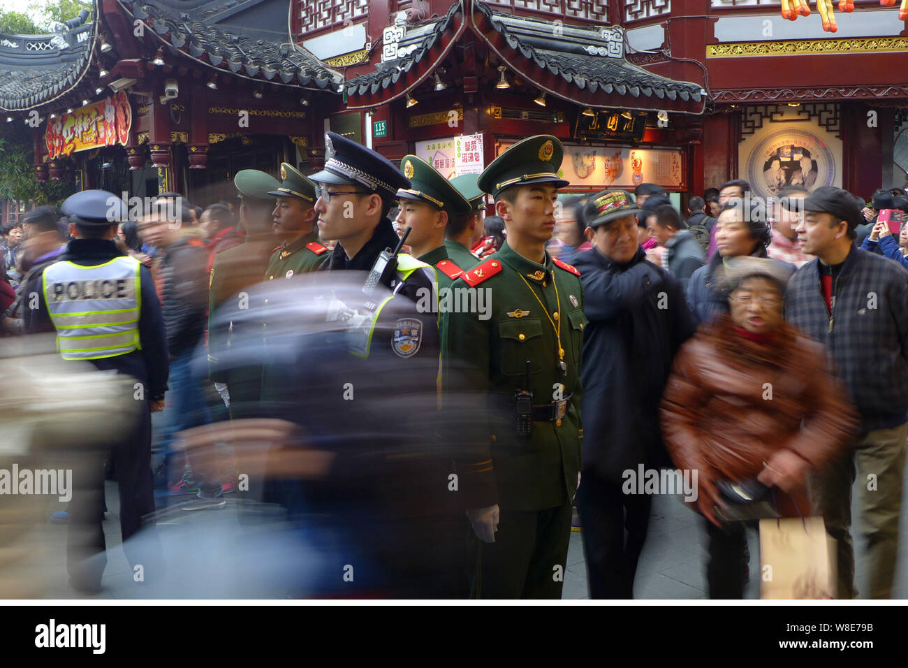Les agents de police et paramilitaires chinois policiers montent la garde en tant que touristes foule Jardin Yu, ou le jardin Yuyuan, au cours de la Nouvelle Année lunaire chinoise holida Banque D'Images