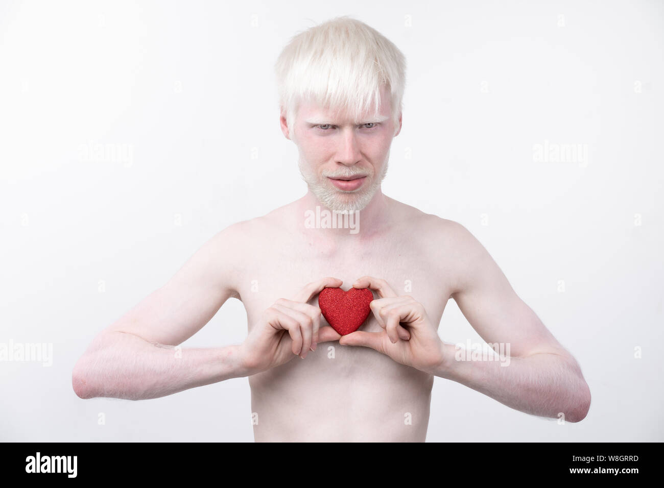Portrait d'un homme albinos dans studio habillé t-shirt isolé sur un fond blanc. déviations anormales. Aspect insolite anomalie de la peau. Banque D'Images