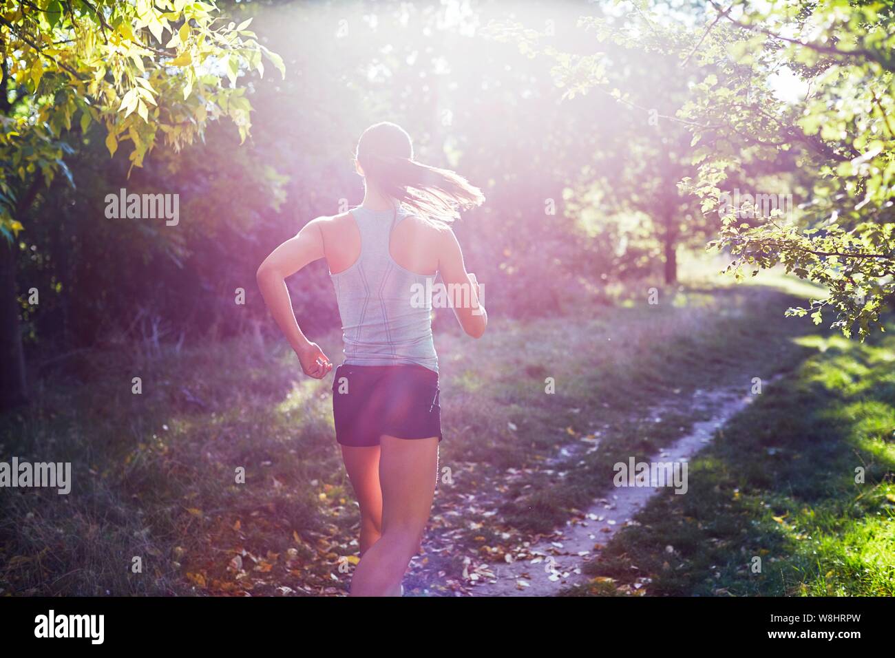 Jeune femme jogging le chemin. Banque D'Images