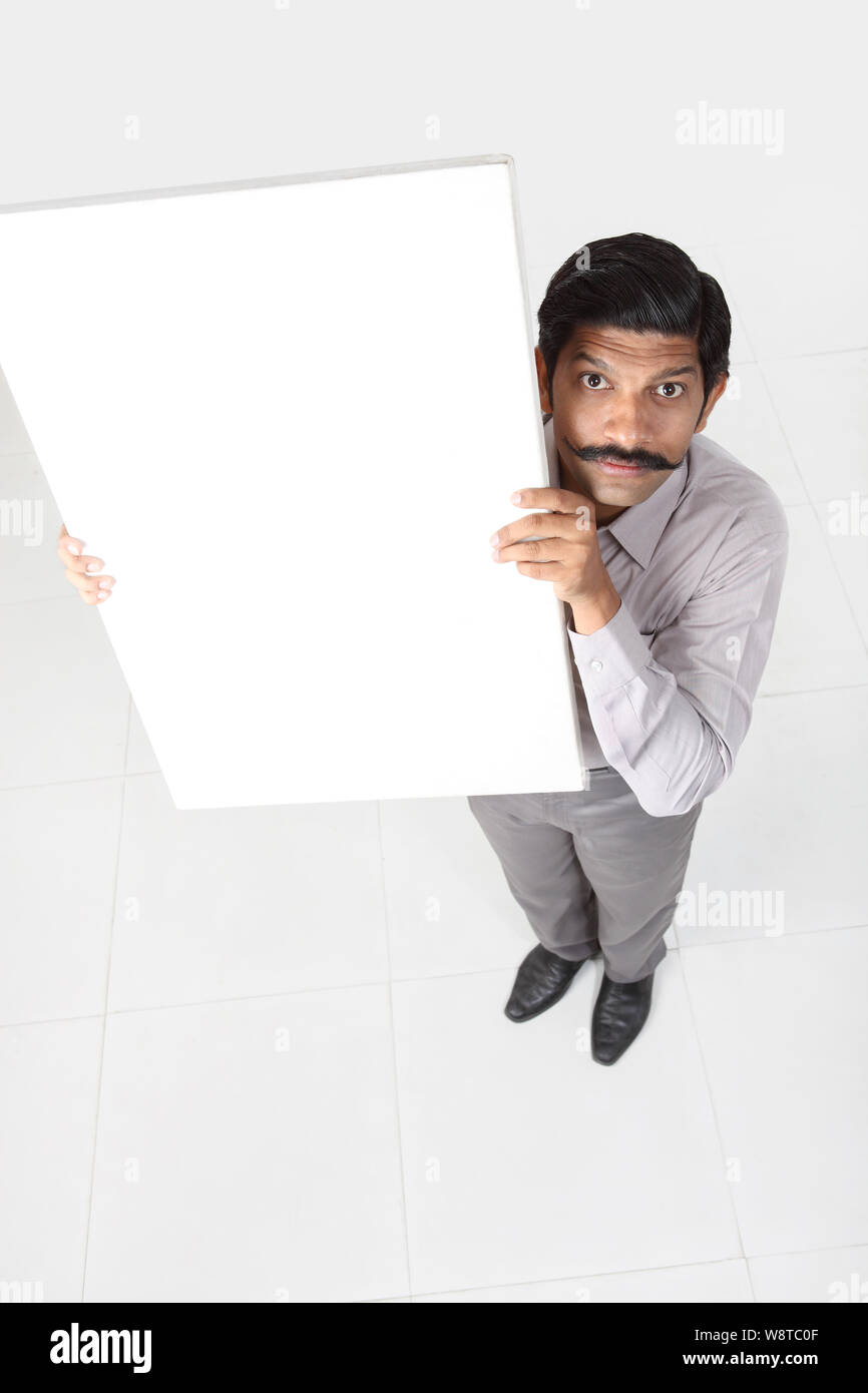 Businessman showing a blank placard et à la peur Banque D'Images