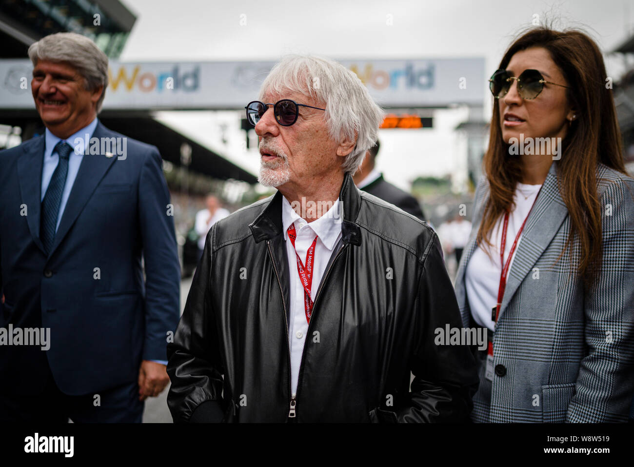 Bernie Ecclestone (C), Président émérite de la formule un groupe et son épouse Fabiana Flosi (R) Promenade à travers la grille de départ avant la course de Grand Prix MotoGP autrichien. Banque D'Images