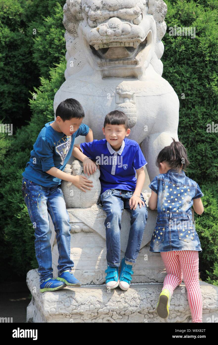 Les enfants chinois escalader un lion en pierre au mausolée de Sun Yat-Sen pendant la journée peut-vacances à Shanghai, Chine de l'est la province de Jiangsu, 1 mai 2014 Banque D'Images