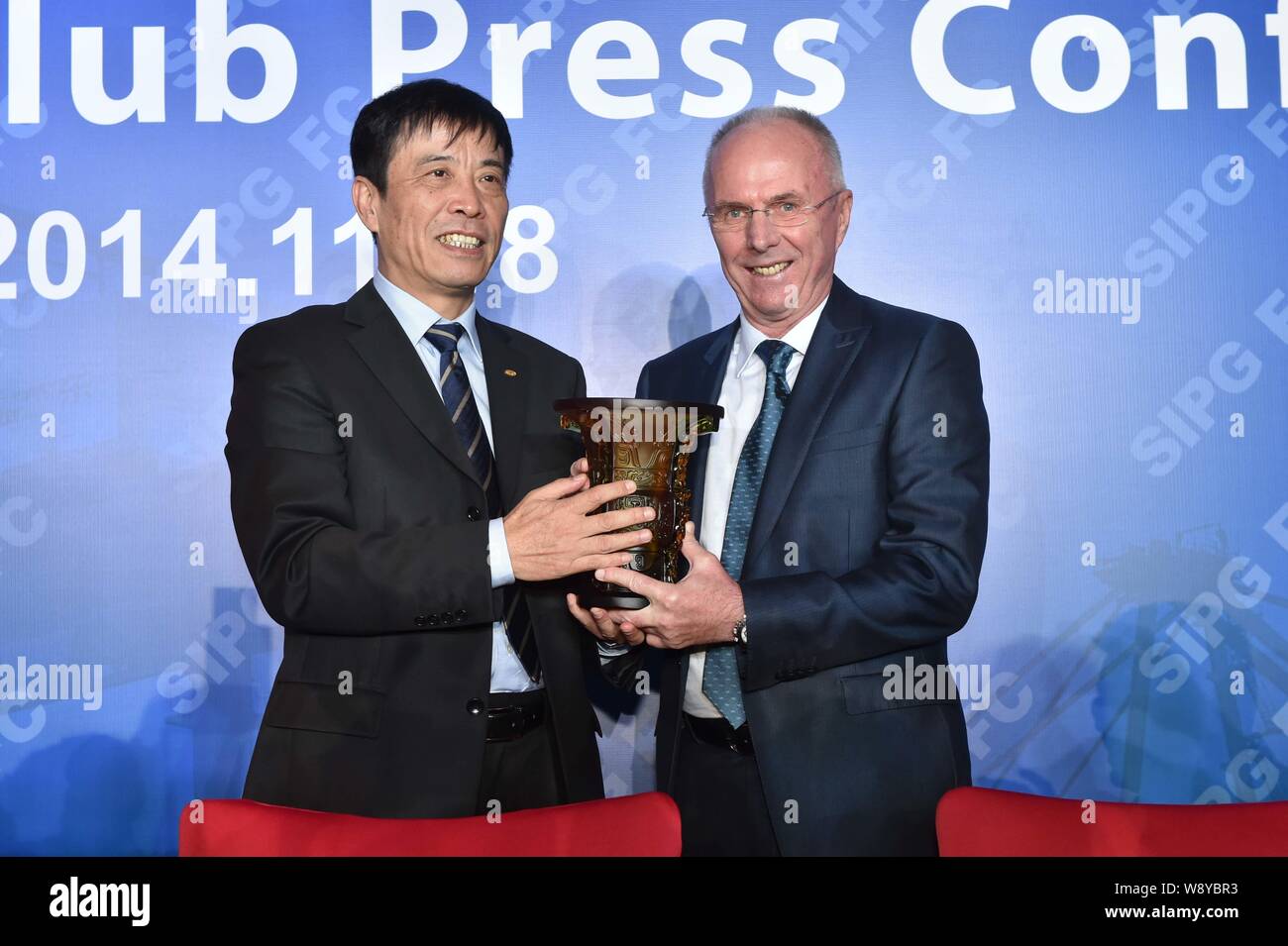 Entraîneur de football suédois Sven-Goran Eriksson, à droite, la nouvelle entraîneure-chef de l'EPOP Football Club, reçoit un cadeau de Chen, président de Baimingwei International Banque D'Images