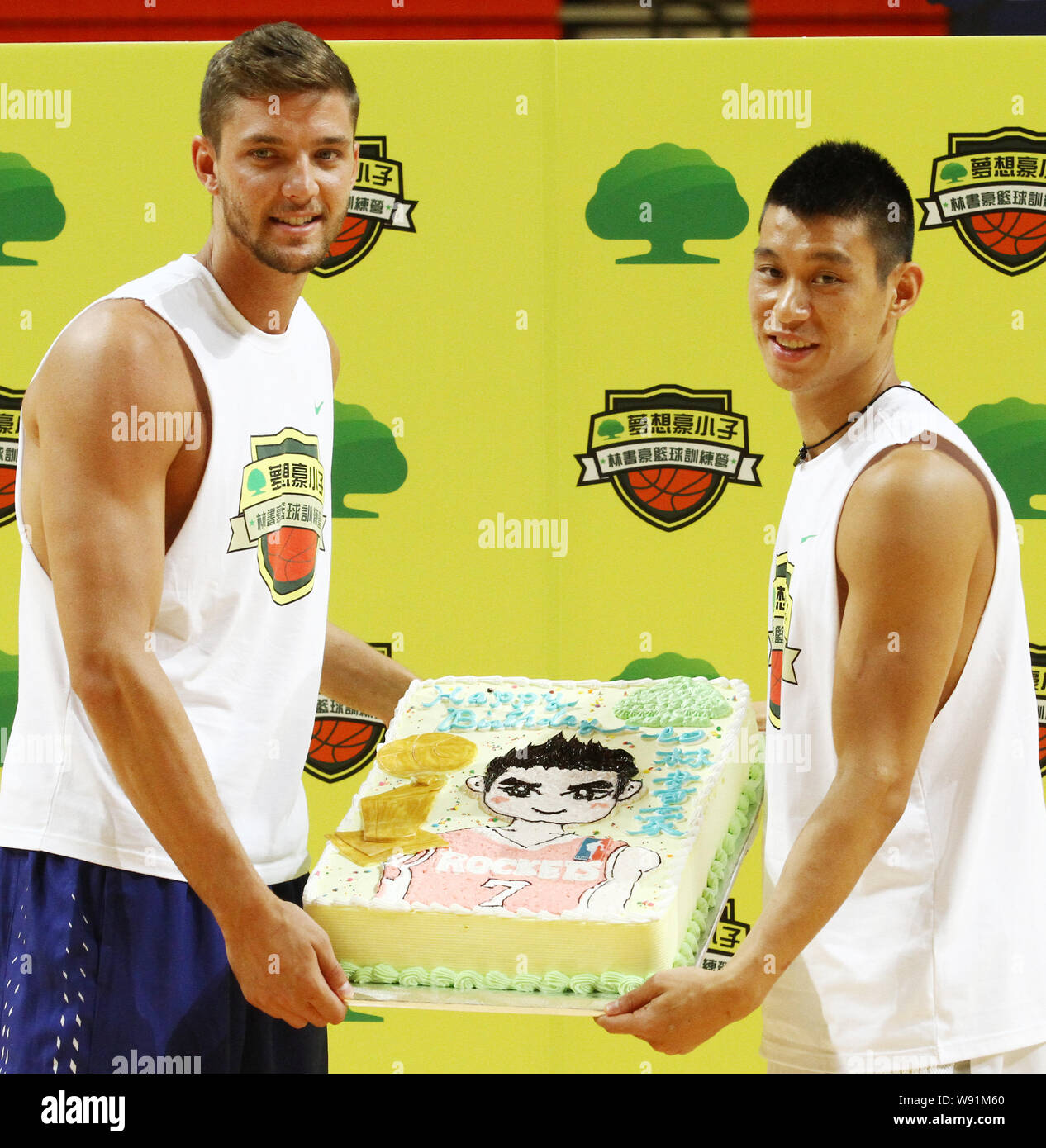 Star de la NBA Jeremy lin de l'équipe de basket-ball des Houston Rockets,  droite, son ami Chandler Parsons, posent avec un gâteau d'anniversaire au  cours de la Jeremy Lin Panier Photo Stock -