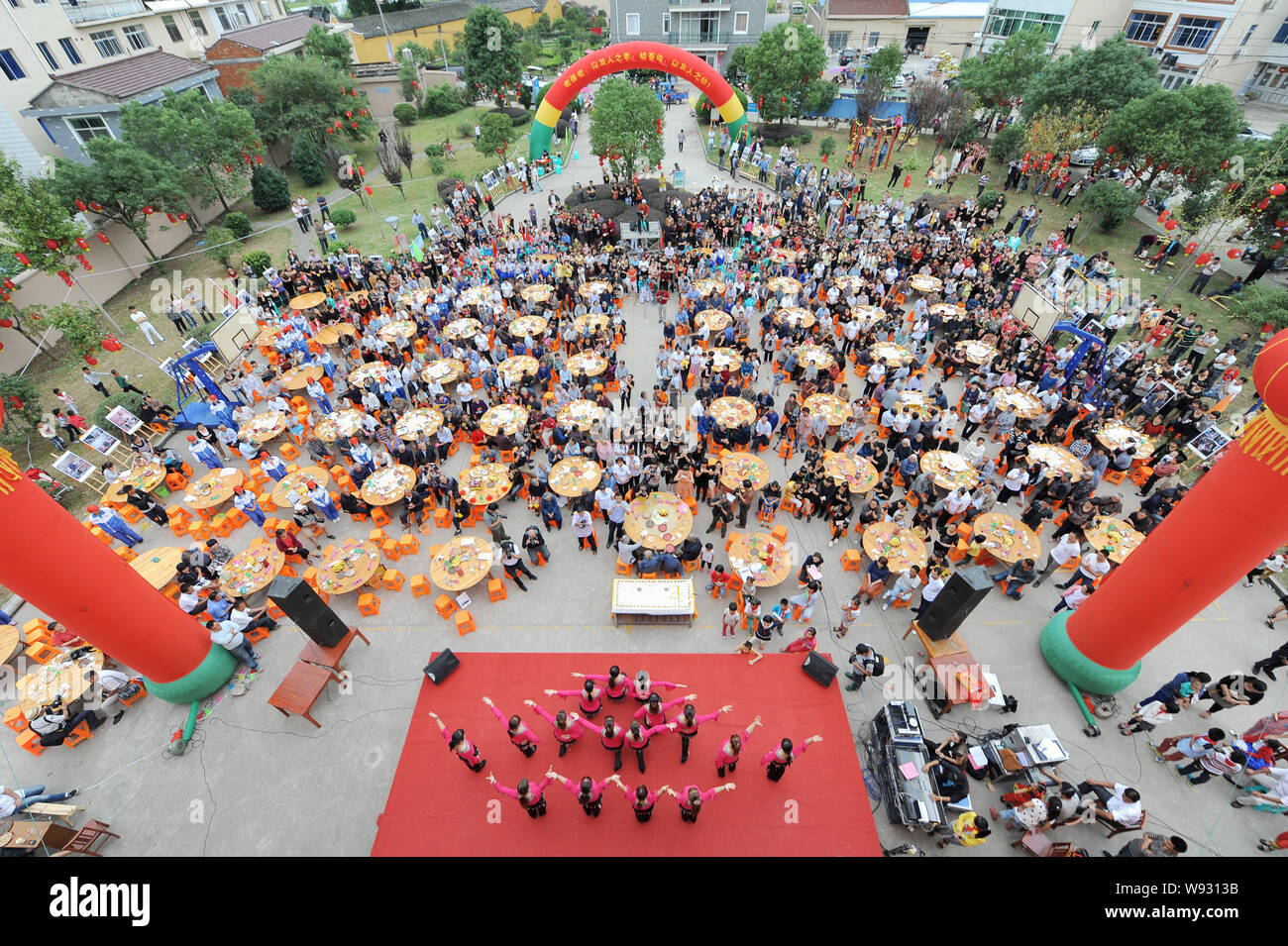 Les personnes âgées locales manger des gâteaux et d'autres aliments autour de tables à la célébration de l'anniversaire dans Dongxidan collective village, ville de Dongcheng, ville de Linhai, ea Banque D'Images