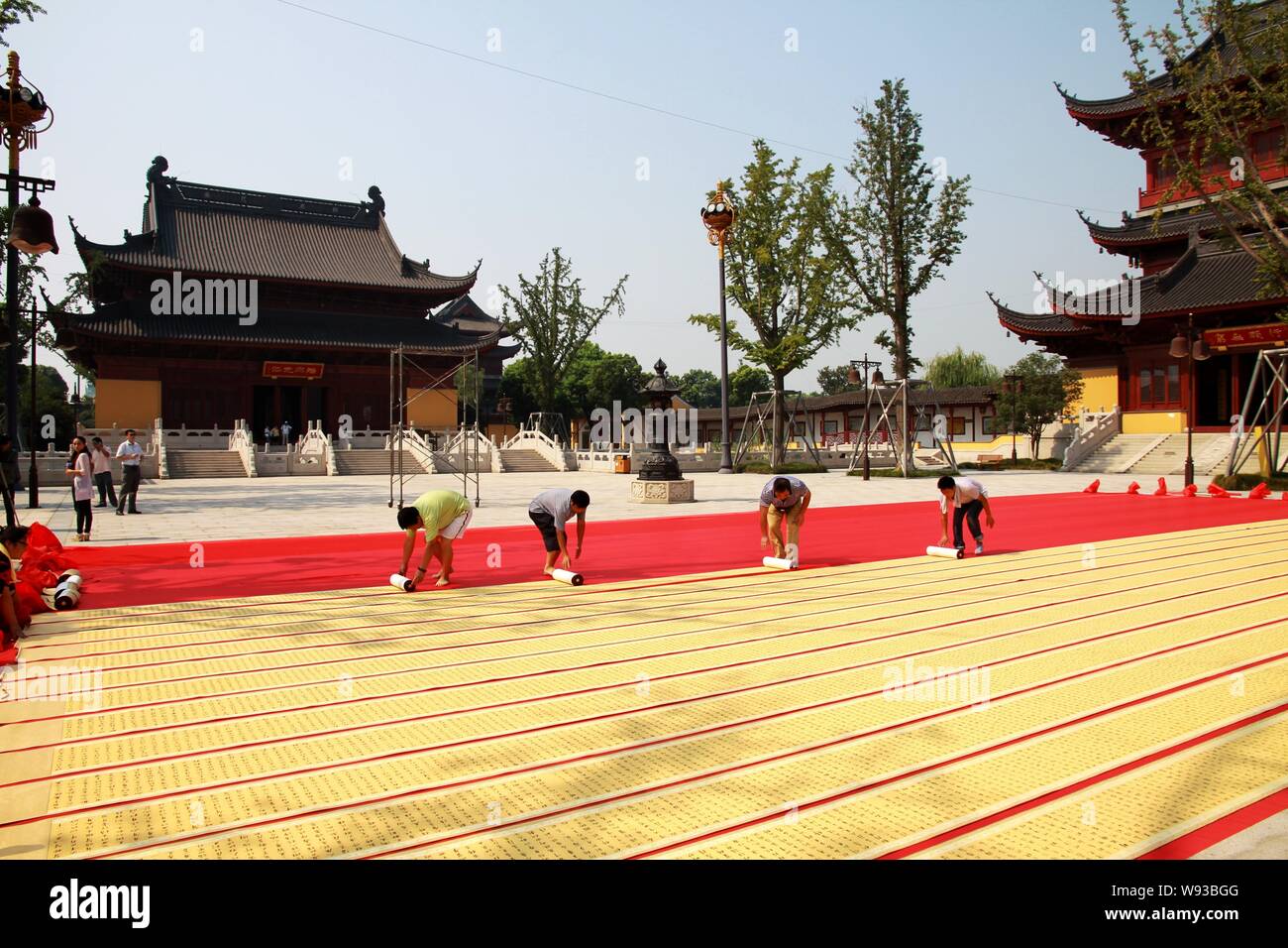 Les employés de l'Association Record du monde défile de dépliage de la calligraphie du nom de Sutra du Lotus créé par Ye Zhaojing pour confirmer sa longueur à Zhongyuan Te Banque D'Images