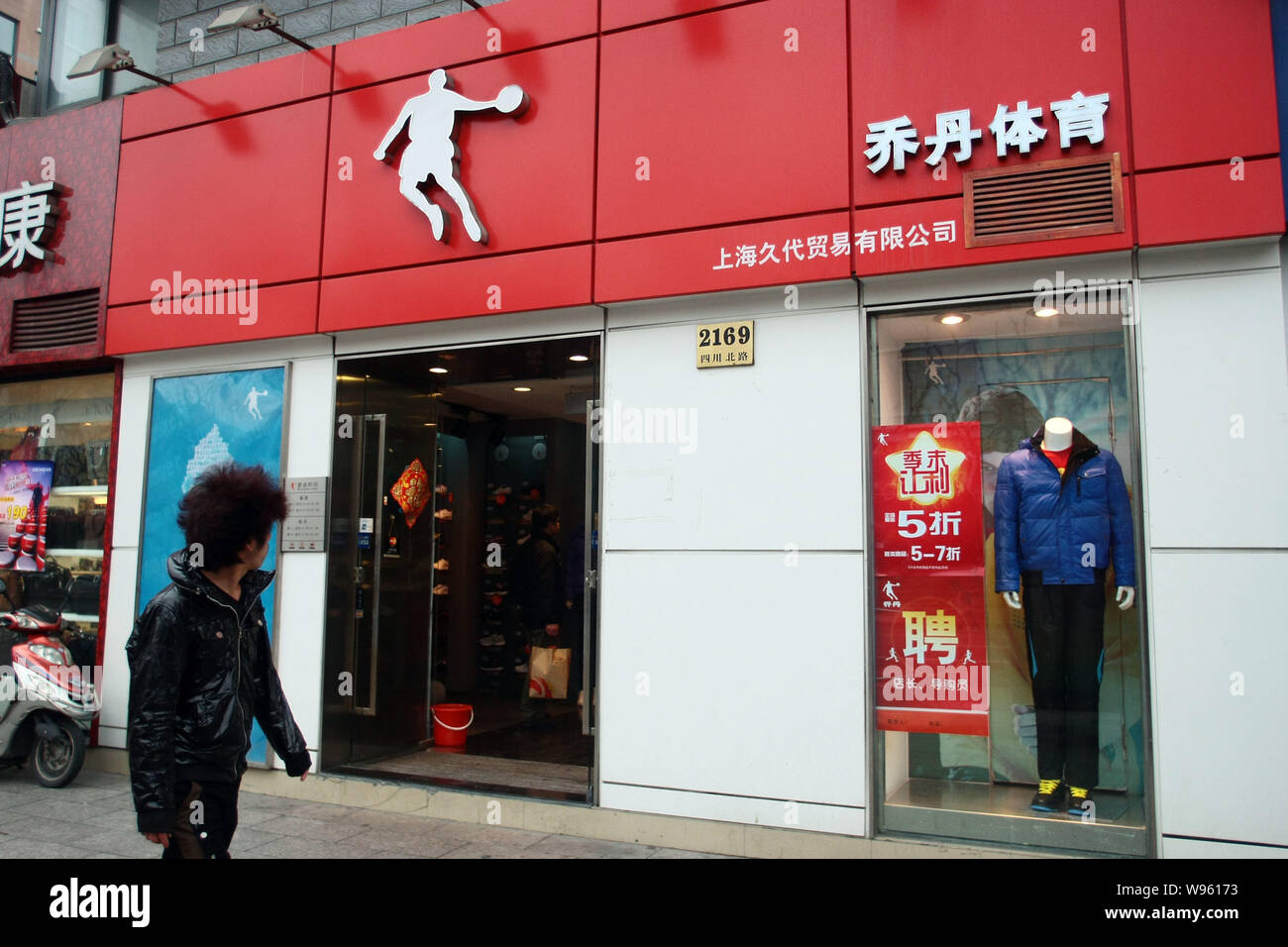 Un piéton passe devant un magasin de sport de Qiaodan, la traduction  chinoise de Jordanie, à Shanghai, Chine, le 23 février 2012. Michael  Jordan, l'h Photo Stock - Alamy