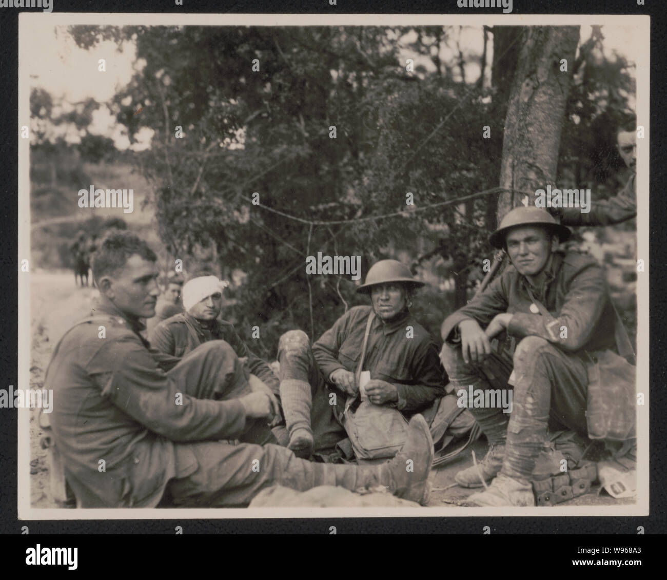 Soldats alliés, dont une avec une tête bandée, assis sur le sol pendant la Première Guerre mondiale Banque D'Images
