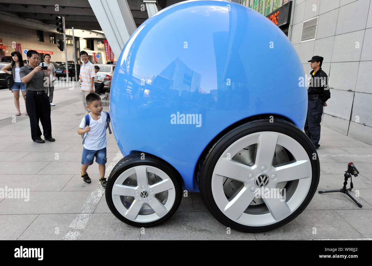 Un jeune Chinois se rapproche de l'enfant un concept-car de Volkswagen autochtones Projet de voiture dans une rue de Zhongguancun, connu sous le nom de Chinas Silicon Valley, dans la région de B Banque D'Images