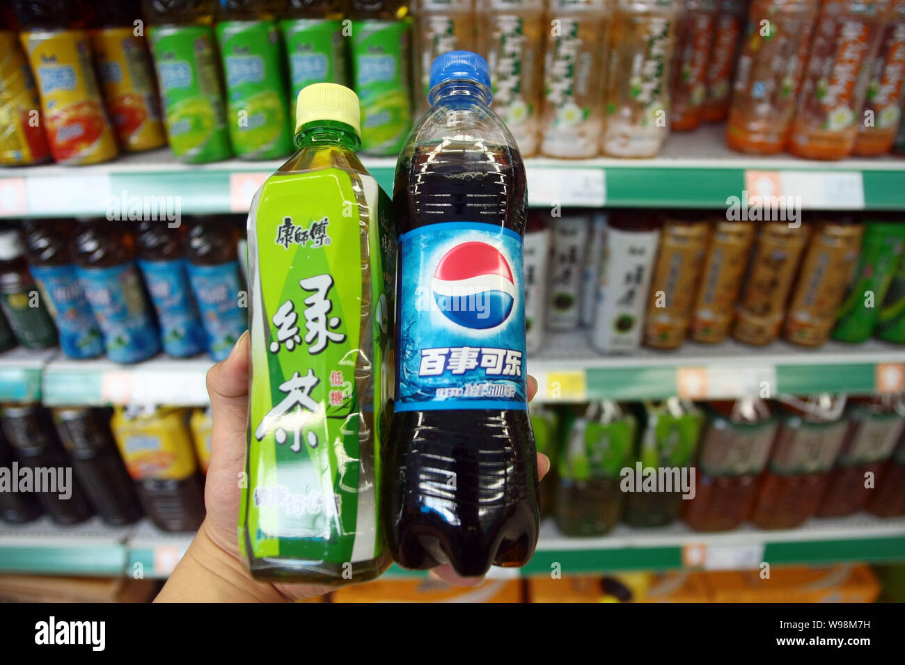 Bouteilles d'ice tea de Maître Kong Tingyi (Îles Caïmanes) Holding Corp. et Pepsi-Cola de PepsiCo Inc. sont présentés dans un supermarché à Shanghai, Chine, Banque D'Images