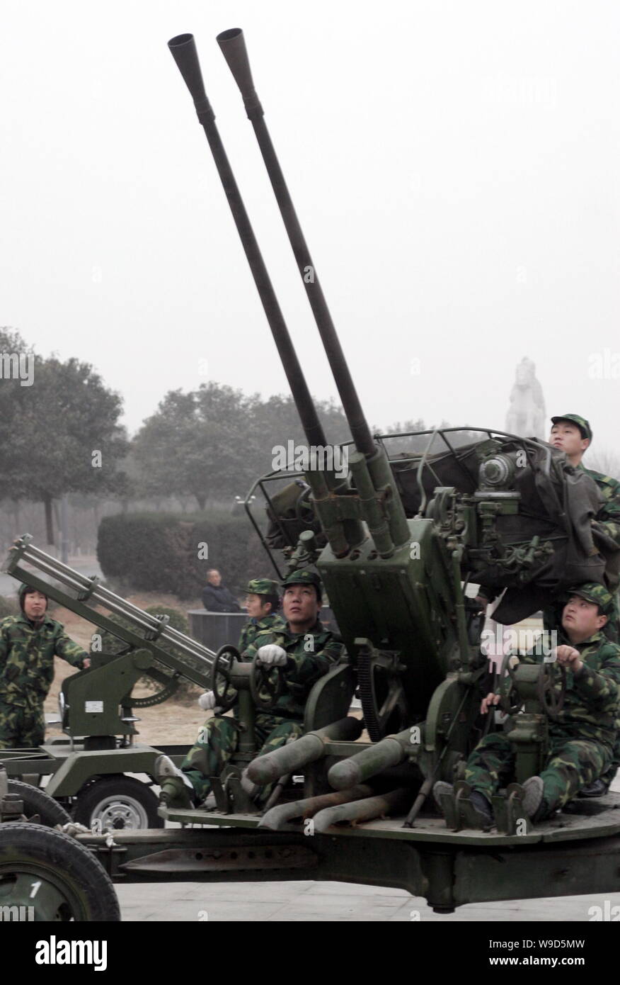 Les travailleurs chinois locaux service météorologique de préparer une artillerie anti-aérienne essaie de nuages de pluie artificielle de semences pour faciliter la sécheresse je Banque D'Images