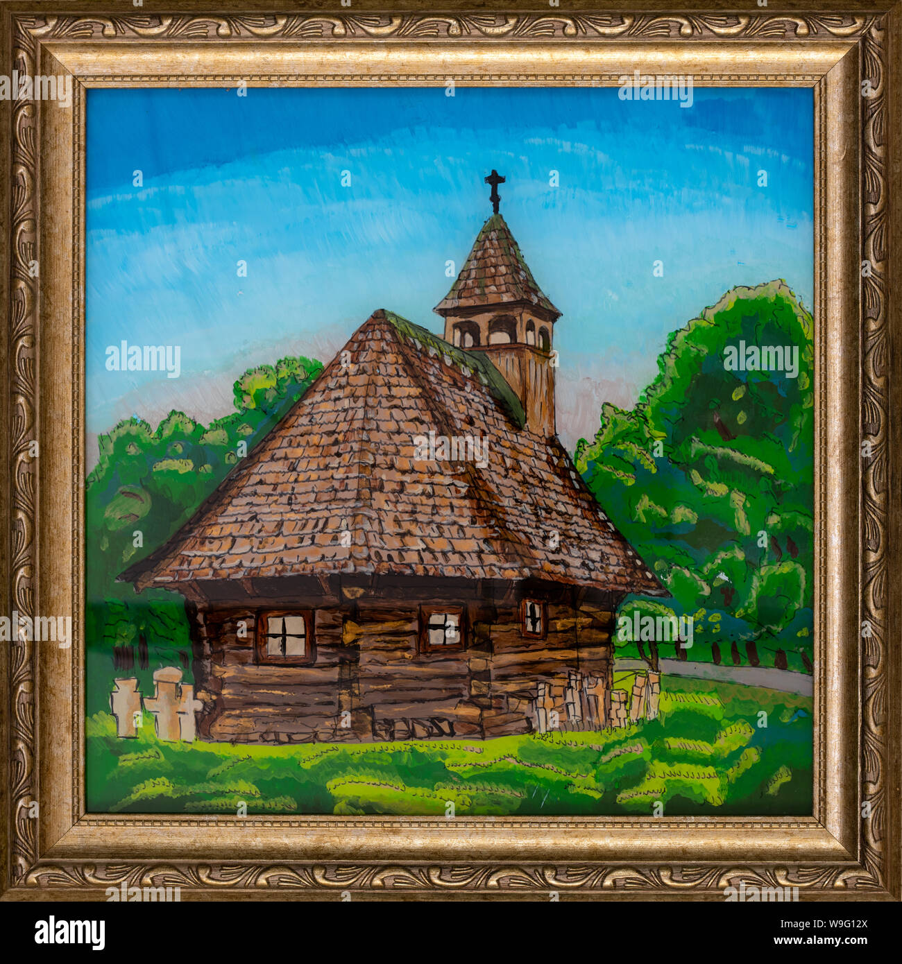 Un cadre peinture sur verre inversé représentant une église en bois typique de la région de Maramures, Roumanie. Banque D'Images