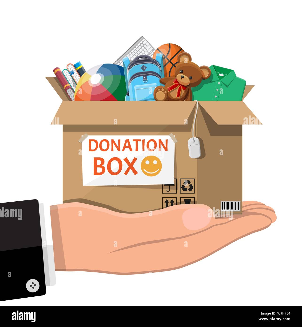 Don en carton boîte pleine de jouets, livres, vêtements et appareils. Aide  pour les enfants, l'aide aux enfants pauvres. Faire un don le récipient  dans la main. La prise en charge sociale,