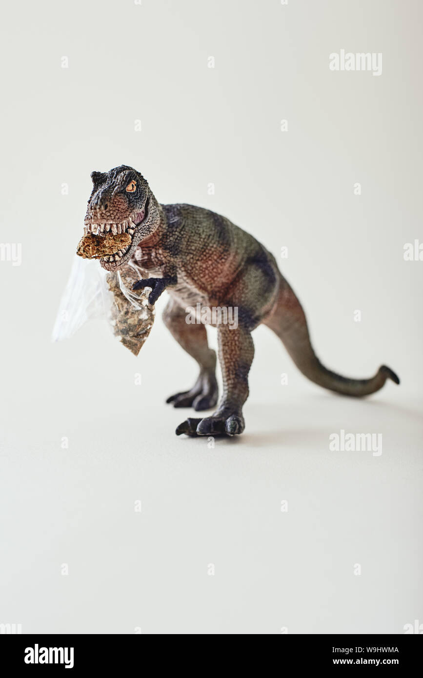 Jouet dinosaure en plastique isolé sur fond clair. Shot verticale Banque D'Images