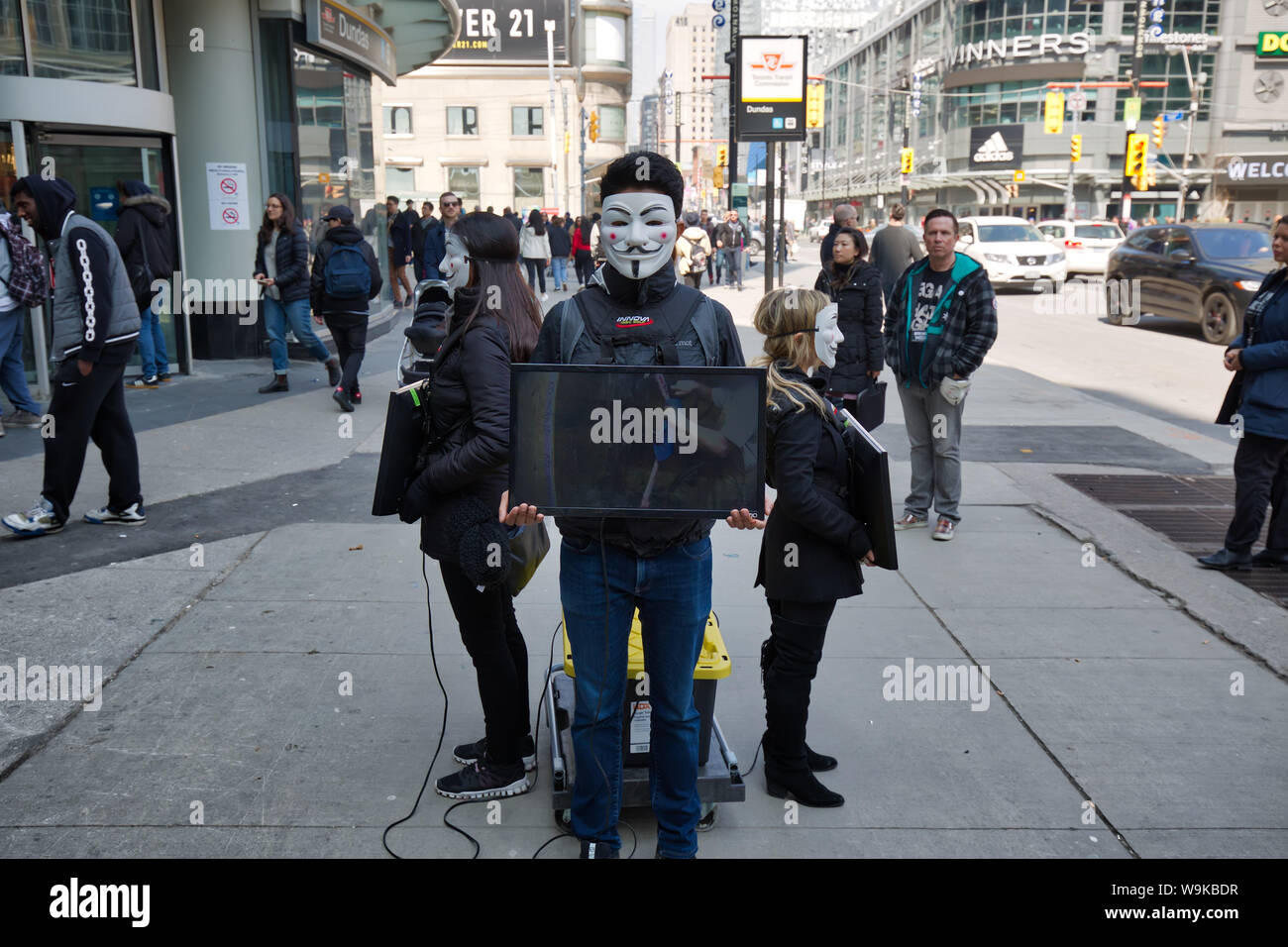 Toronto, Ontario, Canada, 2019 Mars-20 : protestation contre la cruauté envers les animaux par un groupe de jeunes militants portant des masques anonymes et la tenue d'un téléviseur qui Banque D'Images