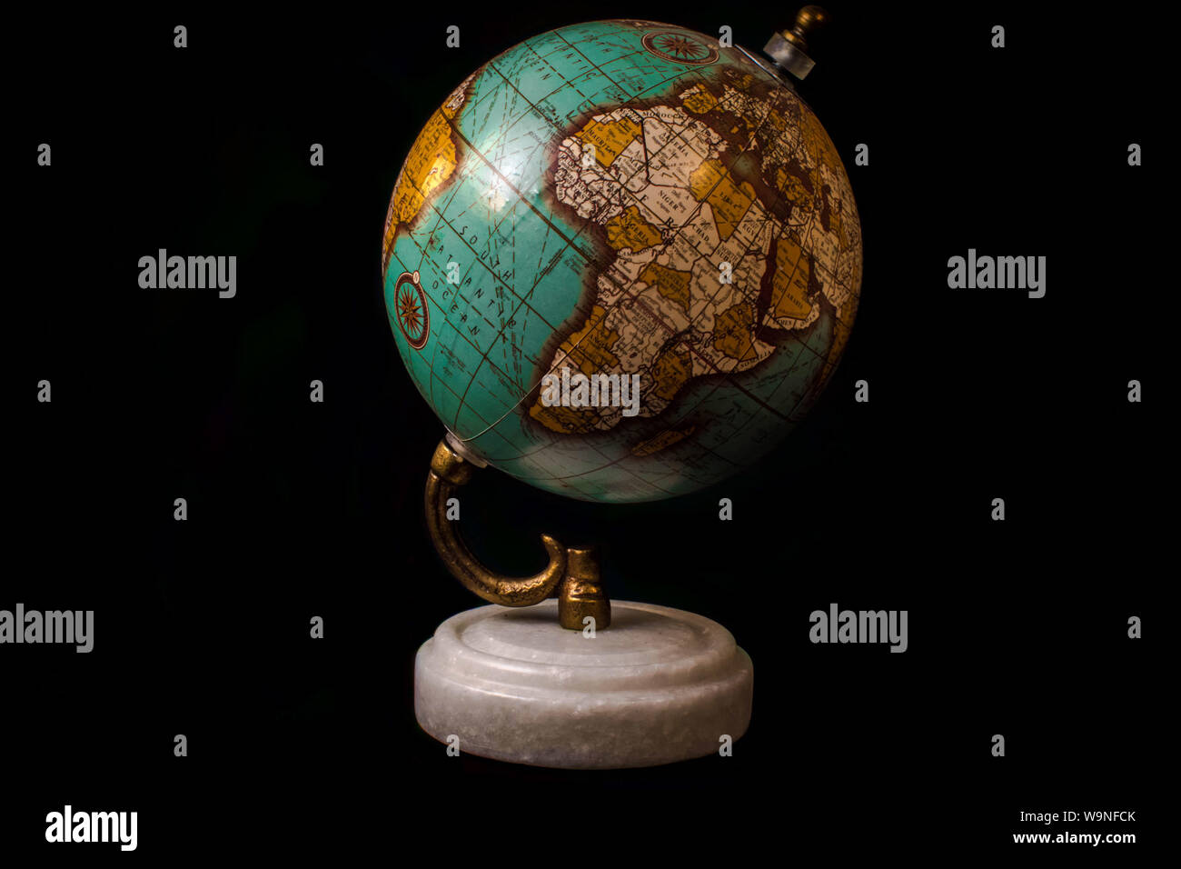 Globe Antique Gold avec un titulaire et un socle de marbre , libre , studiowork , fond noir Banque D'Images