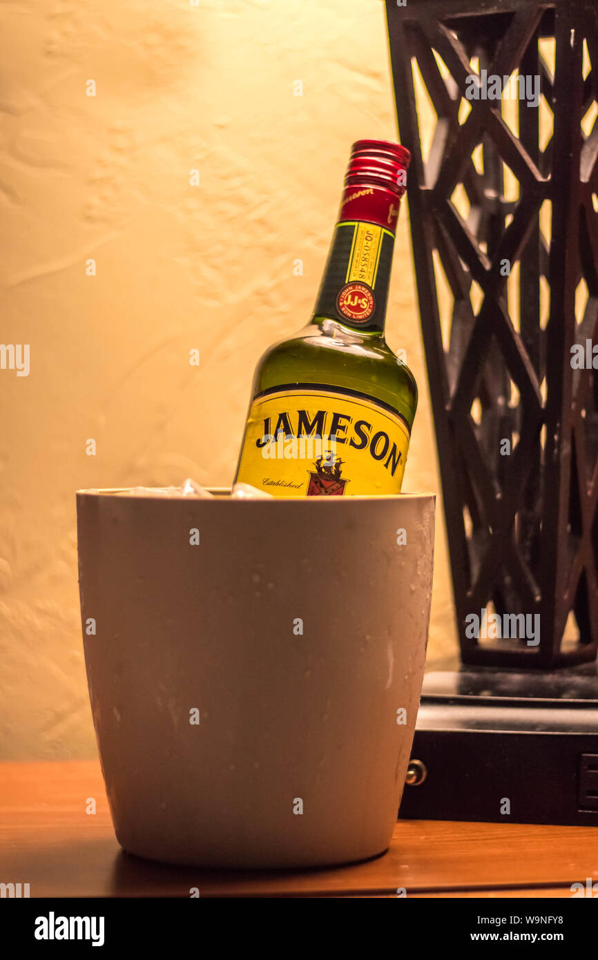 Bouteille de whisky Jameson dans le peut avec de la glace sous la lampe de table Banque D'Images