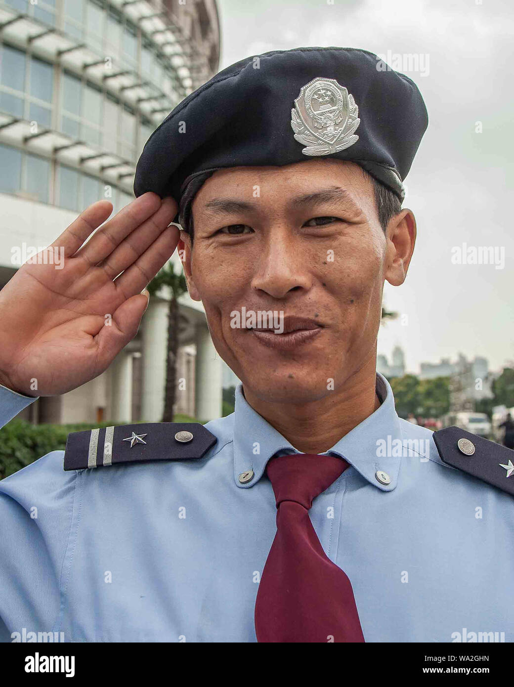 Shanghai, Chine. 30Th Oct, 2006. Un policier de Shanghai, le port d'un béret avec un bouclier, rend hommage au photographe avec un sourire. Credit : Arnold Drapkin/ZUMA/Alamy Fil Live News Banque D'Images