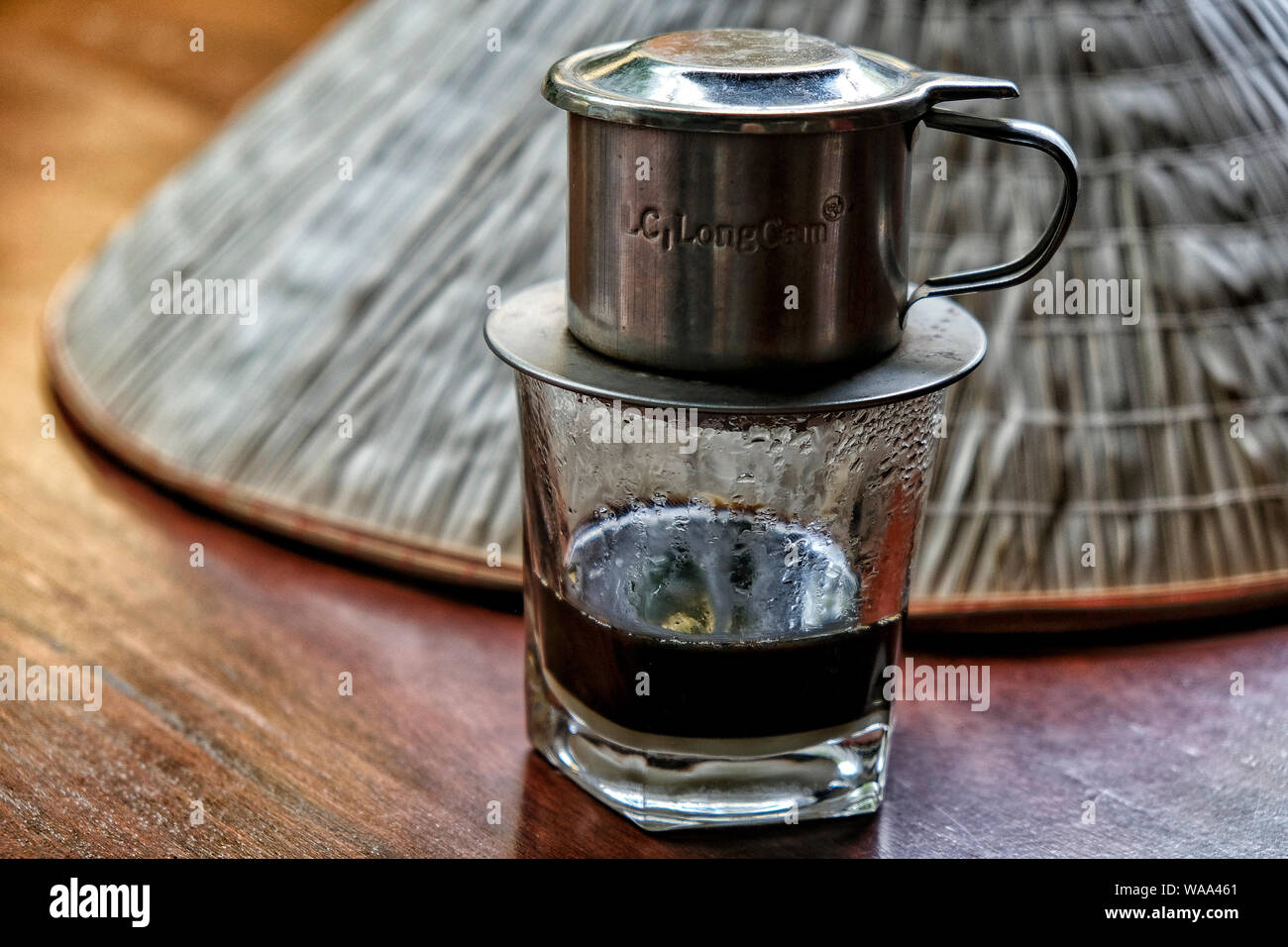 Close-up of a café vietnamien avec un chapeau en arrière-plan. Banque D'Images