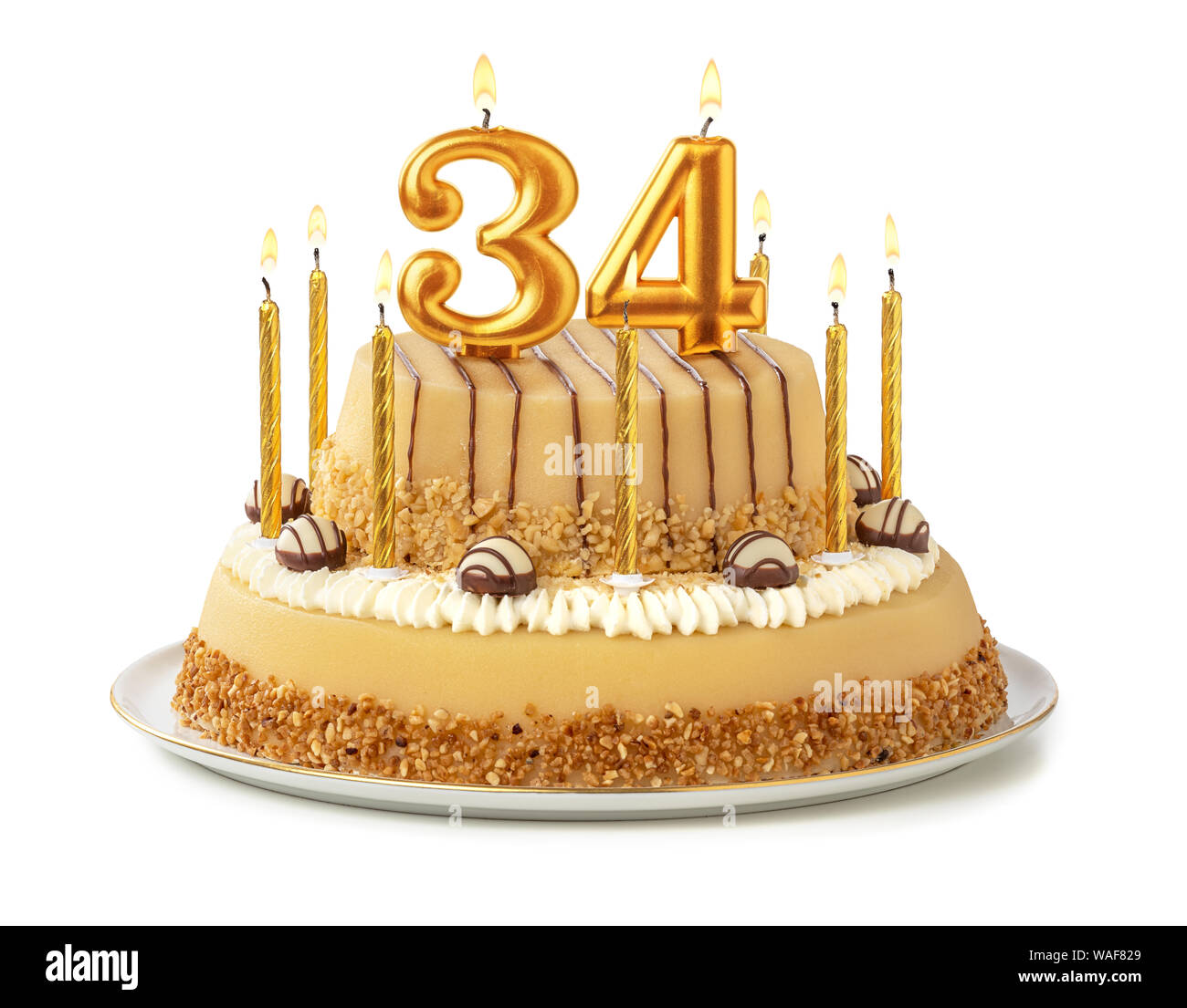 Gâteau de fête avec des bougies d'or - Numéro 34 Photo Stock - Alamy