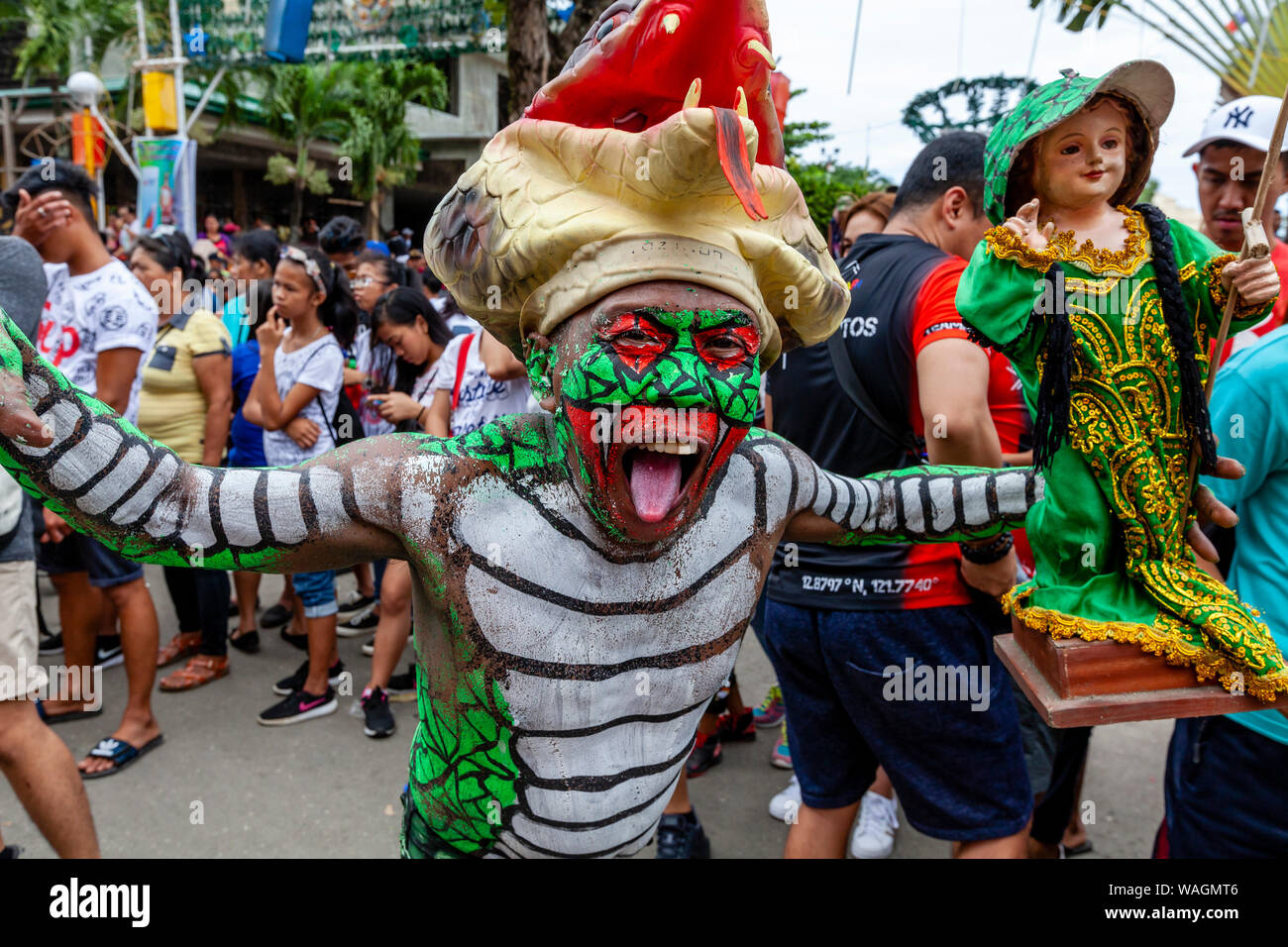 Les gens en costumes colorés Holding Santo Nino Statues parade dans les rues de Kalibo au cours de l'Ati-Atihan Festival, Kalibo, Philippines. Banque D'Images