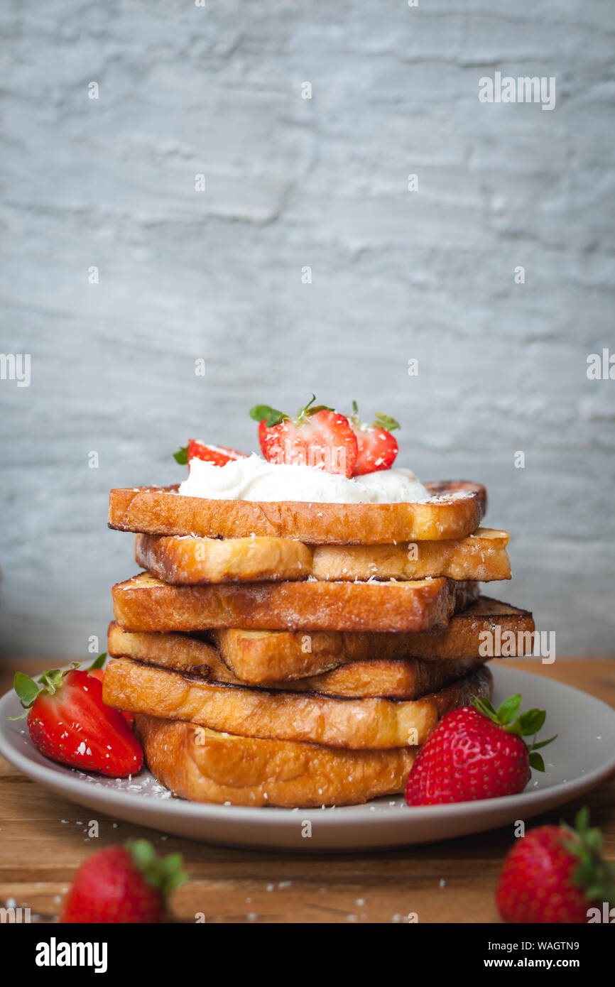 Du pain perdu aux fraises, noix de coco et le miel, sur fond de bois Banque D'Images