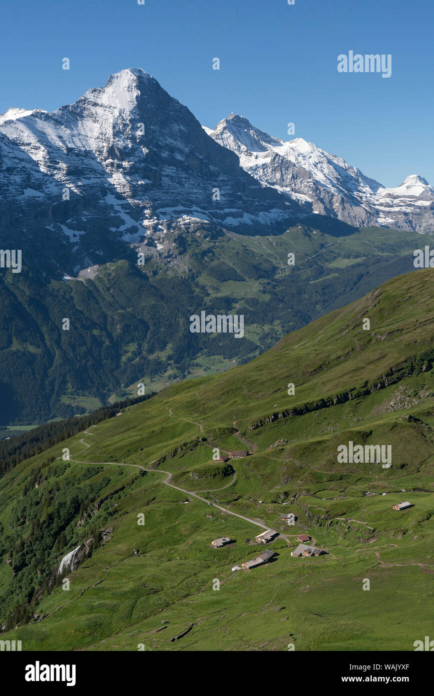 La Suisse, l'Oberland bernois. Un hameau agricole de Schwarzenberg Berg sur le bord d'une pente raide en dessous des sommets alpins au-dessus de Grunewald. Banque D'Images