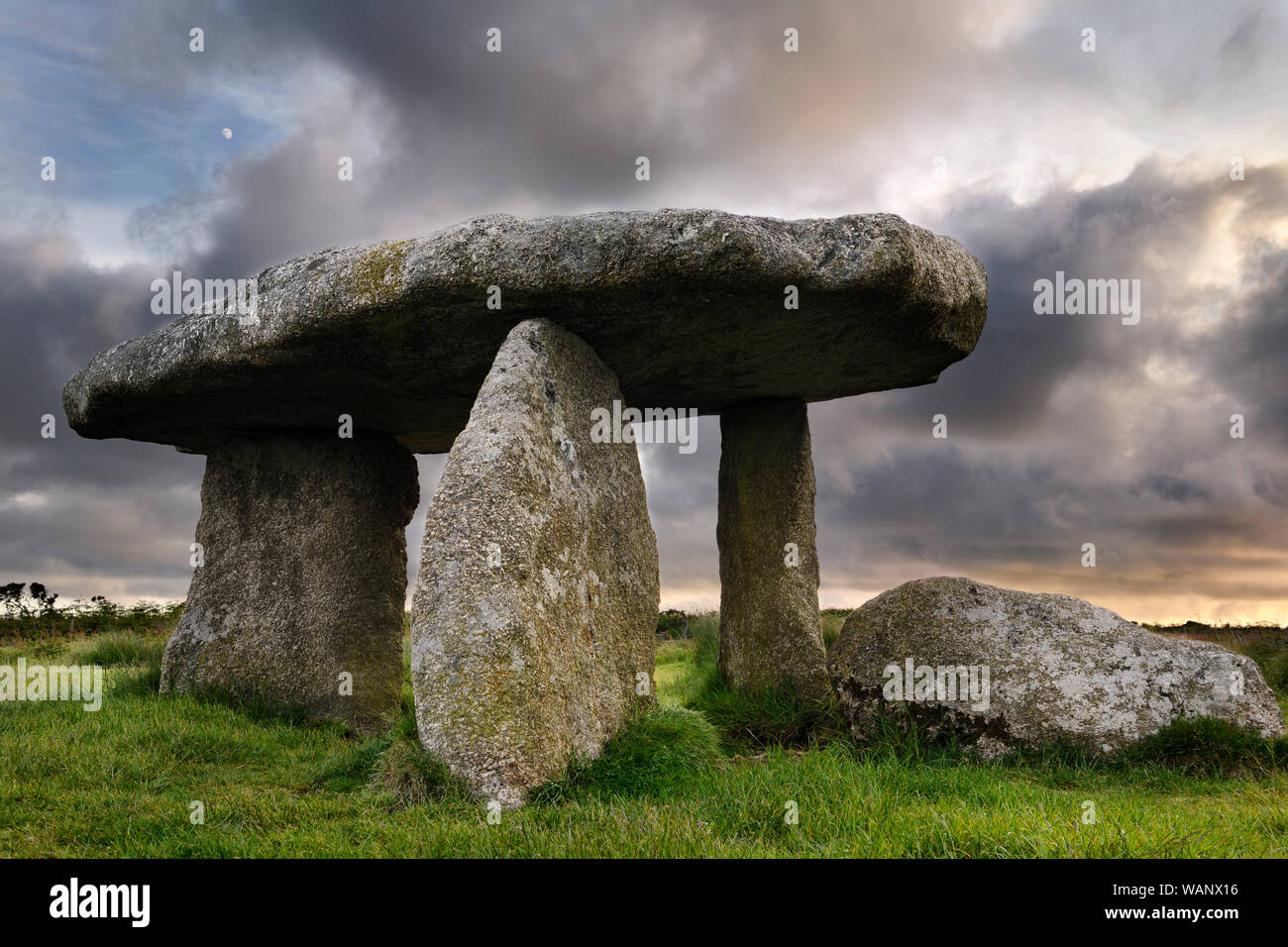 Lanyon Quoit dolmen sépulture néolithique avec pierres mégalithiques trois jambes et 12 tonne tableau capstone à Cornwall en Angleterre au coucher du soleil avec la lune Banque D'Images