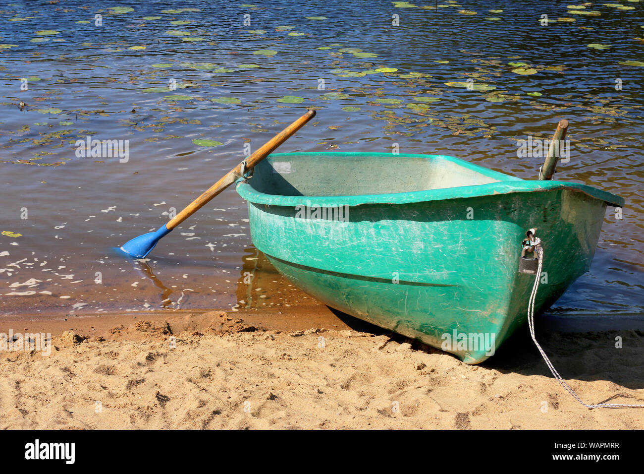 Bateau de pêche dans un lac calme de l'eau. Vieux bateau de pêche dans un lac encore l'eau. L'été. Plage. Lac. Banque D'Images
