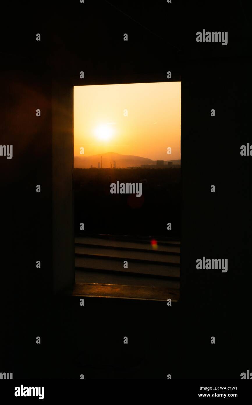 Vue verticale d'un beau coucher de soleil à travers une fenêtre Banque D'Images