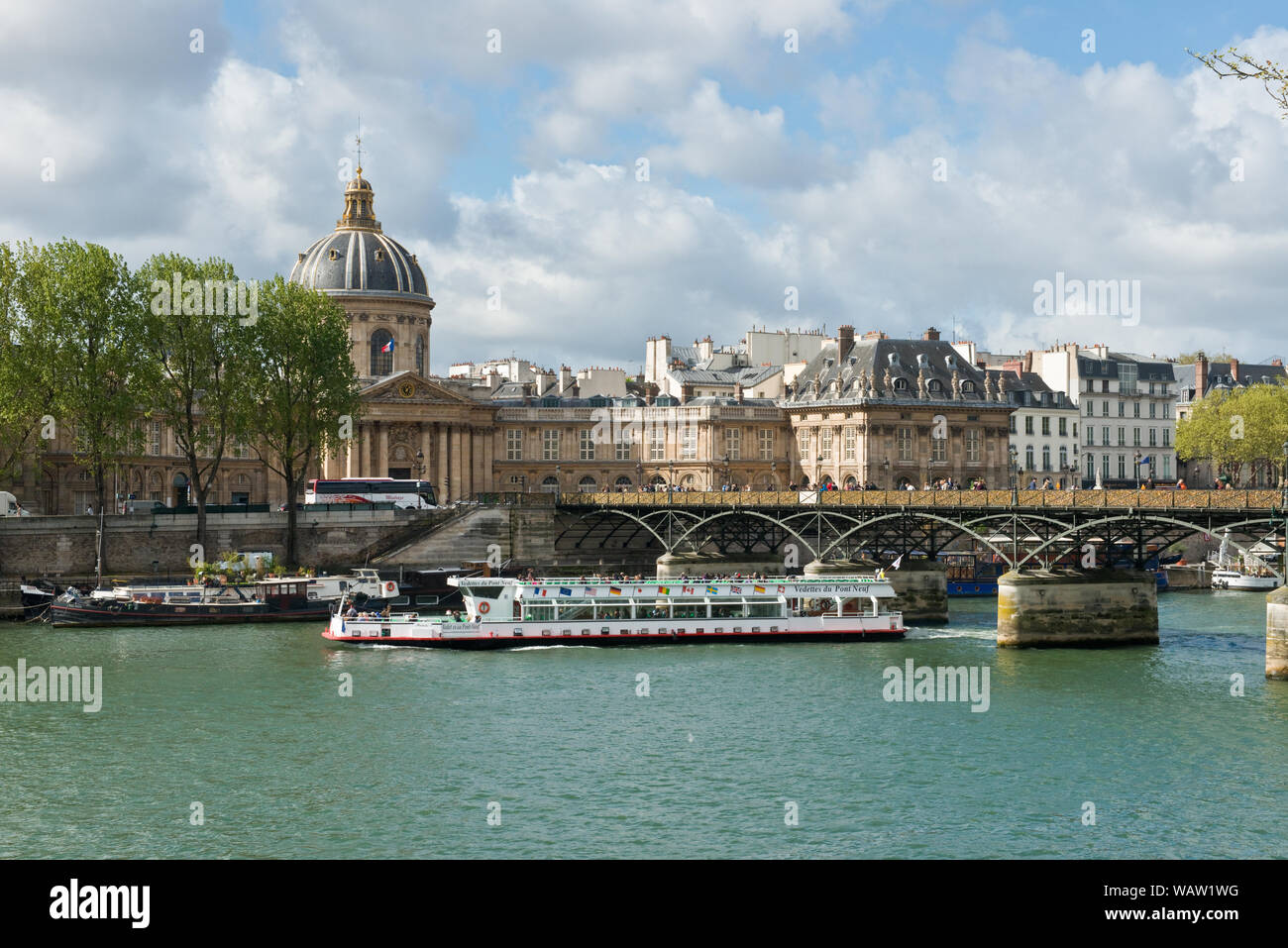 Bateau de croisière passant sous pont de Artes passerelle la Seine à l'Institut de France. Paris, France. Banque D'Images