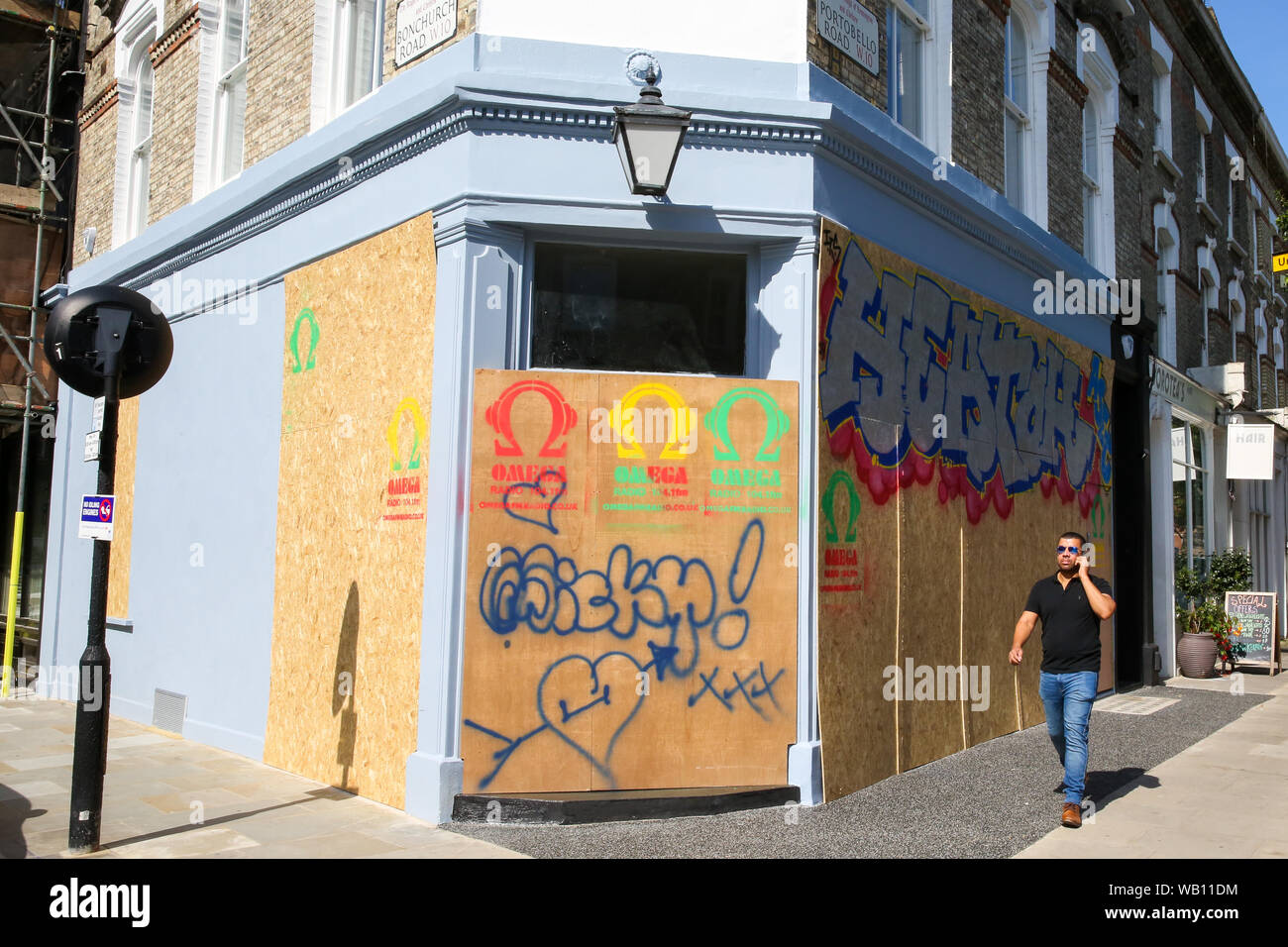 Londres, Royaume-Uni. Août 22, 2019. Un piéton devant une propriété placardées avec graffiti au Ladbroke Grove en avant du carnaval de Notting Hill dans l'ouest de Londres. Crédit : Steve Taylor/SOPA Images/ZUMA/Alamy Fil Live News Banque D'Images