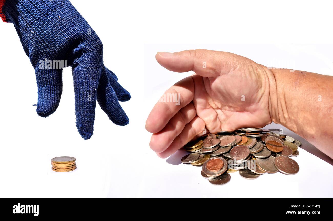 Alors que les salaires du travail reçoivent peu de risque d'énormes bénéfices, part en bleu gant est ramasser petite quantité de pièces, main embrasser l'argent Banque D'Images