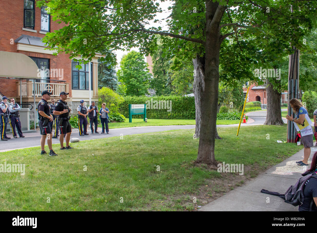 OTTAWA, ONTARIO, CANADA - Le 23 août 2019 : Un militant et d'agents de police partager un moment de reconnaissance mutuelle pour la paix comme une protestation conclut. Banque D'Images