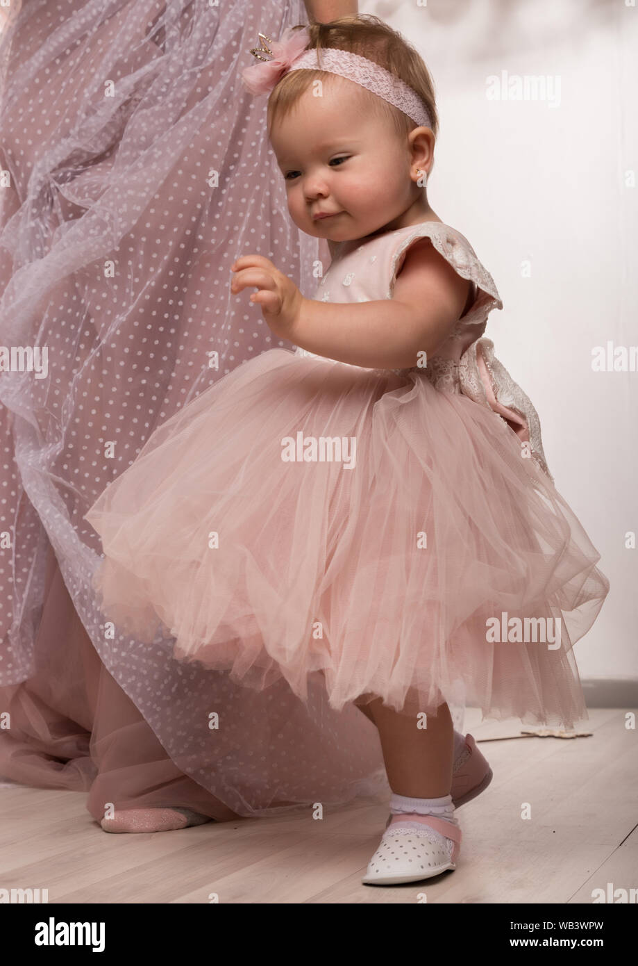 très tendance, petit bébé en robe rose. petite princesse pose comme une  poupée Photo Stock - Alamy