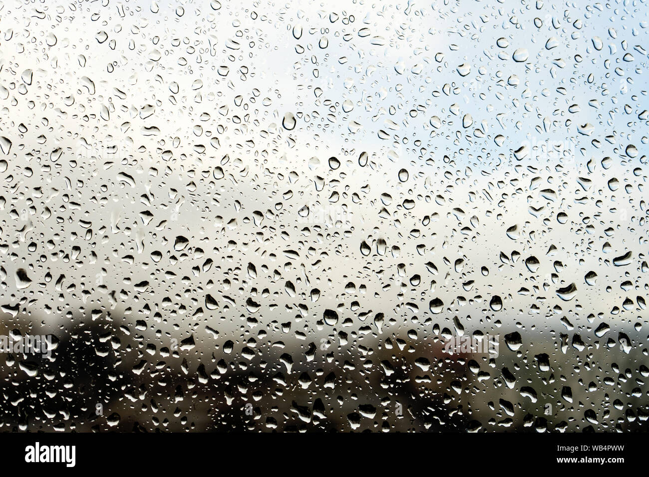 Gouttes de pluie sur la fenêtre. Paysage à travers le verre humide. Métaphore de la mauvaise humeur, la dépression et la tristesse Banque D'Images