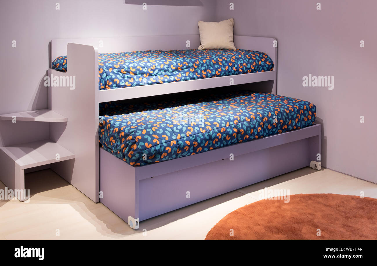 Lits superposés dans une petite chambre à coucher avec une literie colorée  et décor violet offrant une solution à deux enfants de couchage Photo Stock  - Alamy