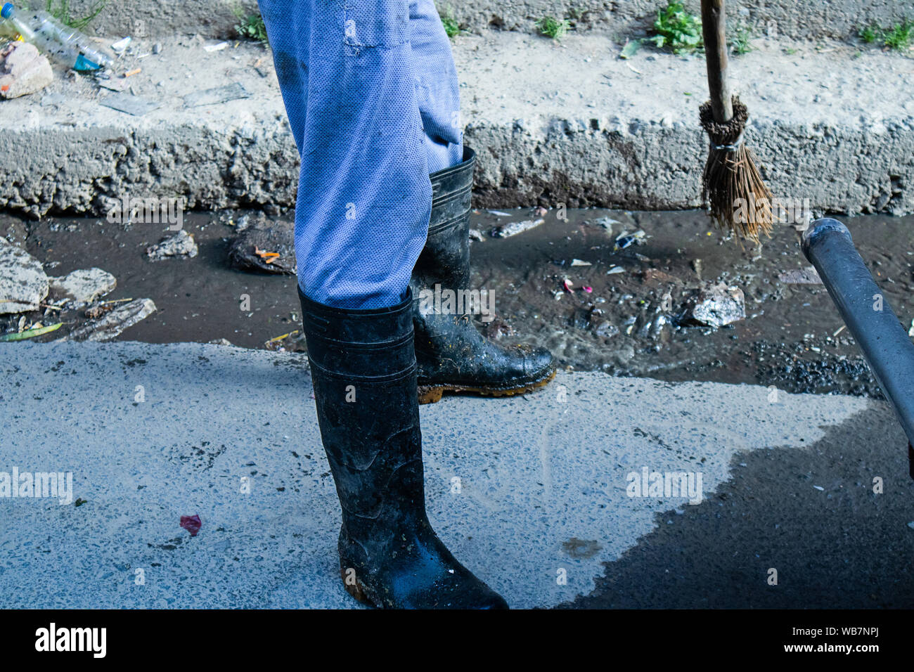 Shimla, Himachal Pradesh, Inde - Juillet 20th, 2019 : employé municipal balayer le système routier et de drainage avec balai et collecte sélective des déchets, l'accent Banque D'Images