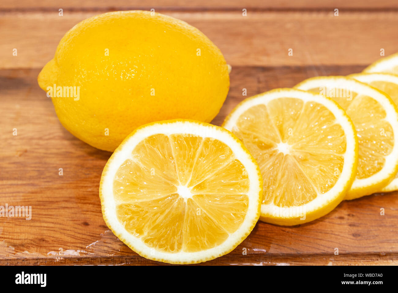 Fruits frais citron jaune avec demi-coupe sur le bois pour les jours chauds d'été et bon pour la santé Banque D'Images