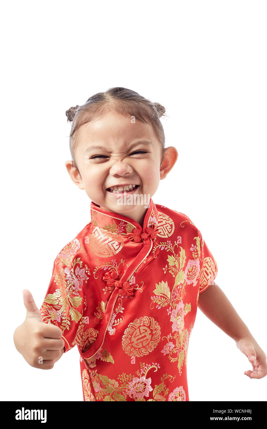 Portrait Of Smiling Girl Showing Thumbs Up Against White Background Banque D'Images