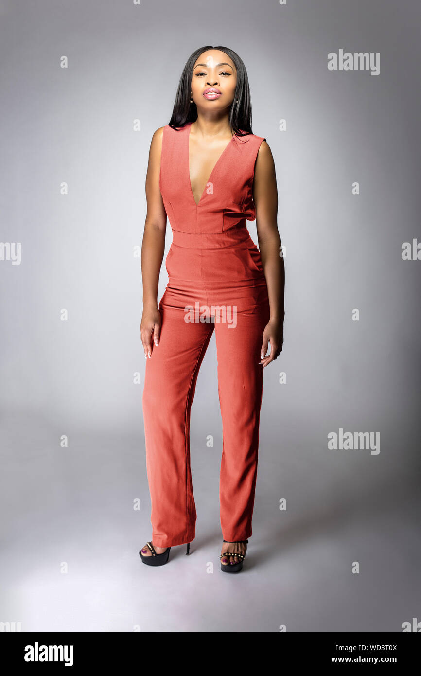 Belle black African American fashion model posing with orange ou