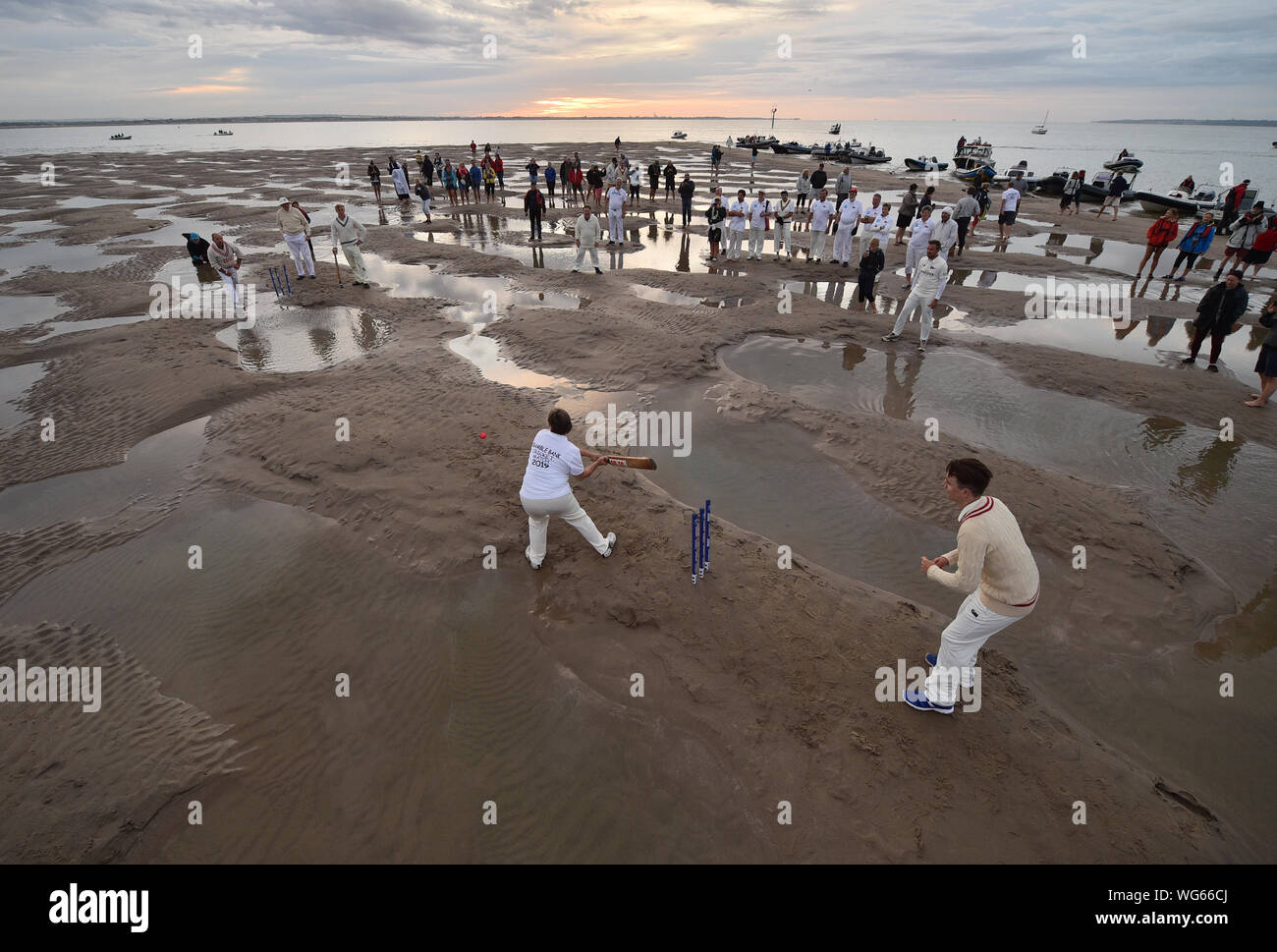 Les membres de la Gendarmerie royale Le sud du Yacht Club et le Club de voile de l'île de prendre part à l'assemblée annuelle de ronces de cricket entre les clubs, qui a lieu sur le banc de sable de mûre Bank au milieu du Solent à marée basse. Banque D'Images