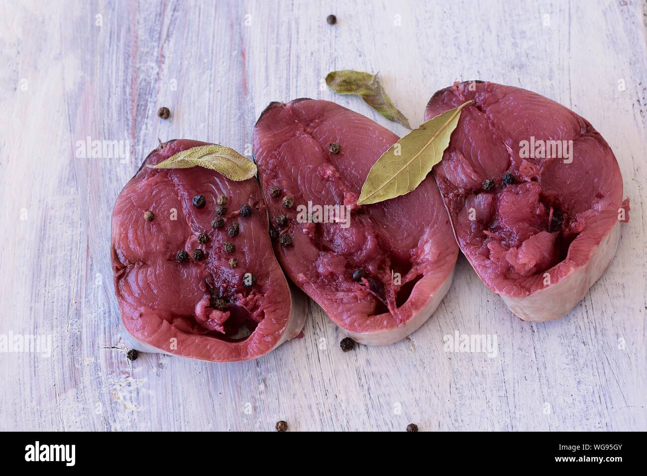 Libre de matières matières premières traditionnelles Bonito Thon filet de poisson avec le poivre noir et la sauge et prête pour la cuisson des aliments Gros plan/ background Banque D'Images