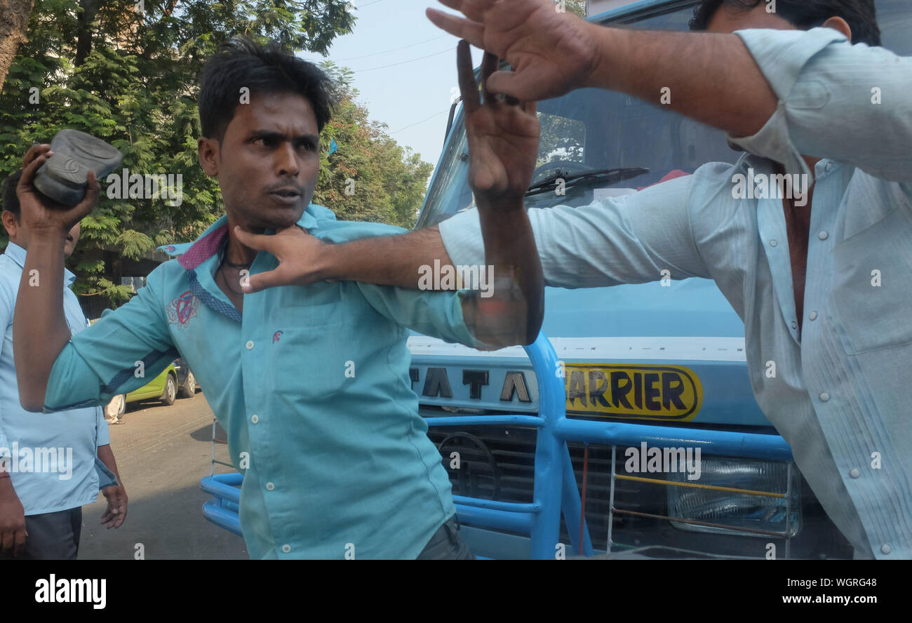 Dans un conflit de circulation à Mumbai, en Inde, un chauffeur de camion essaie de frapper un chauffeur de taxi avec sa chaussure, battant s/o avec une chaussure étant un signe de mépris Banque D'Images