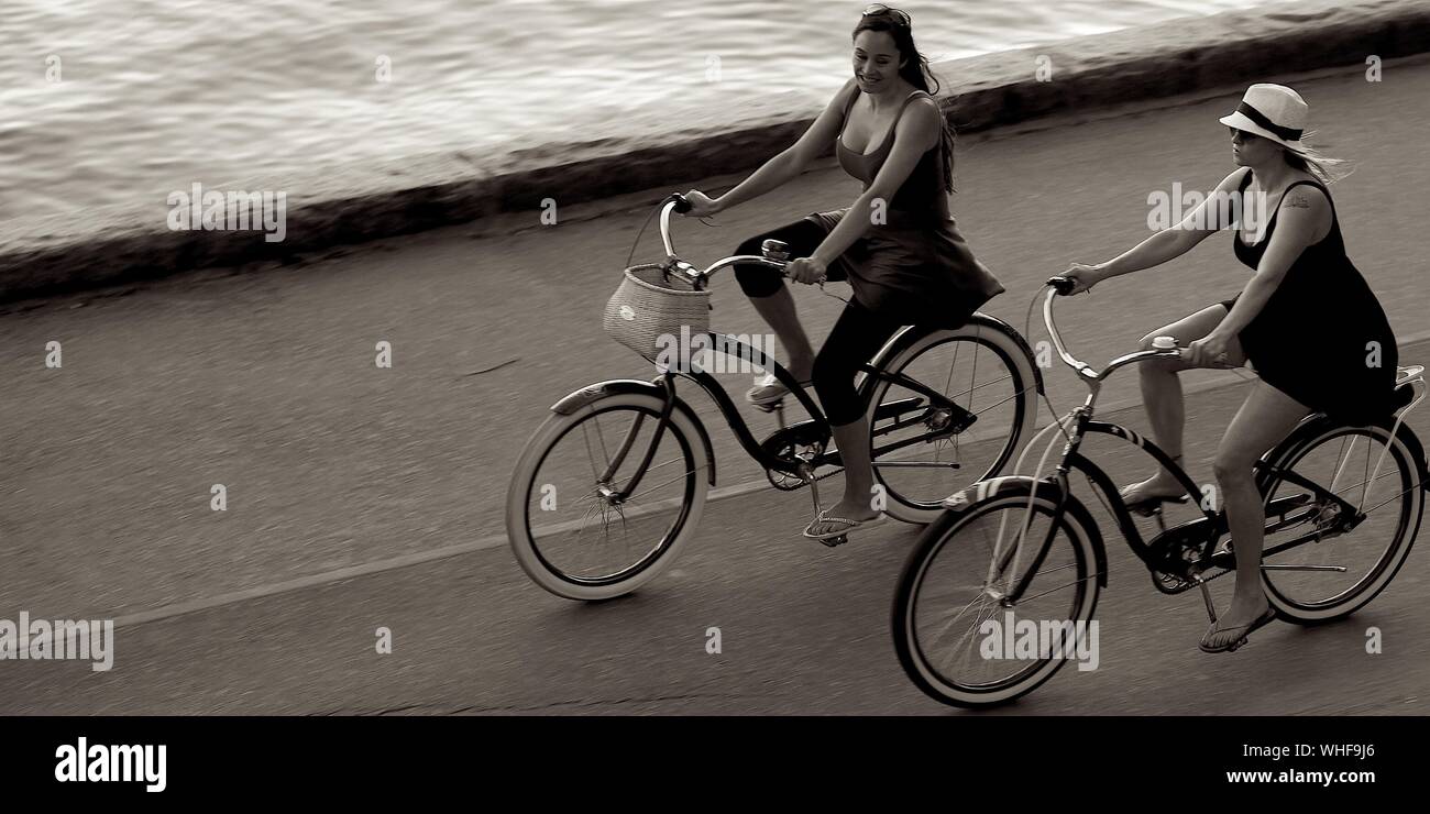 Jolies femmes sur les bicyclettes Banque D'Images